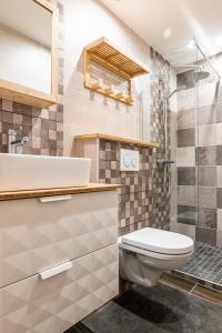 a bathroom with a toilet and a sink and a shower at L'Anneciano - Balcon - Chambre - Vue in Annecy