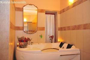 a bathroom with a white sink and a mirror at Kastélyszálló Wellness Resort Sóstó in Nyíregyháza