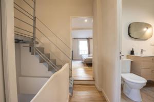 a bathroom with a staircase and a toilet in it at L'antiquaire - 3 chambres - Hypercentre - Wifi in LʼIsle-sur-la-Sorgue +19 photos