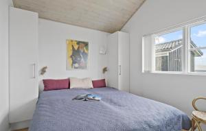 a bedroom with a bed and a window at Stunning Home In Haderslev With House Sea View in Haderslev