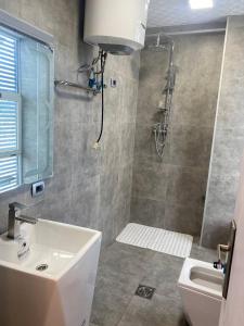 亞的斯亞貝巴的住宿－Buhe Plaza Guest House，带淋浴、盥洗盆和卫生间的浴室