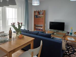 sala de estar con sofá azul y mesa en Metro Dzialdowska - Peace and comfort, en Varsovia