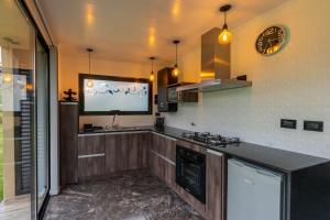 a kitchen with a tv on the wall at Casa Vida in Sierra de los Padres