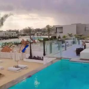 a view of a pool at a resort at Sand Castle Villa Azha - 2 bedrooms - Next Tanoak Hotel in Ain Sokhna