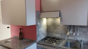 a kitchen with a stove and a sink at Consumella24 in Portoferraio