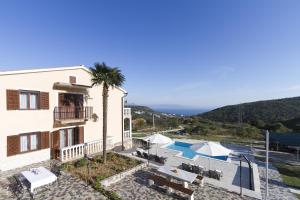 a villa with a view of the pool and the ocean at Apartments Rajkovic in Labin