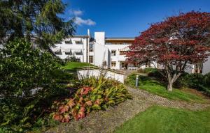 a large white building with a garden in front of it at Lovely Apartment In Stavanger With Kitchen in Stavanger