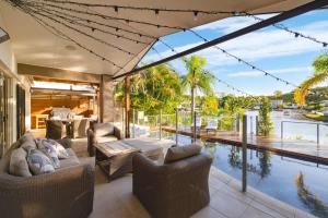 an open living room with a pool and a view at Habourlights 5BR River Front Private Pool & Dock in Gold Coast