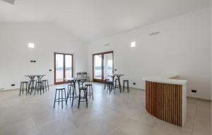 een groep tafels en stoelen in een kamer bij Amazing Apartment In Moscufo With Outdoor Swimming Pool in Moscufo