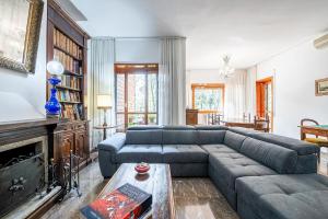 a living room with a couch and a fireplace at [Lungarno] Casa esclusiva in Florence