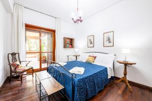 a bedroom with a bed and a chair and a window at [Lungarno] Casa esclusiva in Florence