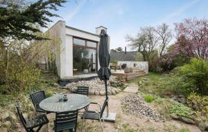 a patio with an umbrella and a table and chairs at Pet Friendly Home In Eg With Wifi in Egå