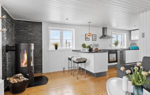 a kitchen and a living room with a fireplace at Amazing Home In Otterup With Kitchen in Otterup