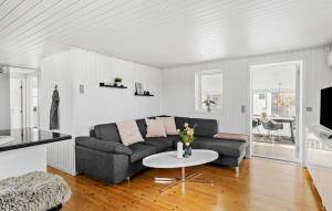 a living room with a couch and a table at Amazing Home In Otterup With Kitchen in Otterup