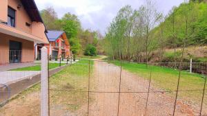 a fence in front of a yard with a house at Villa near the River-Ferizaj in Ferizaj