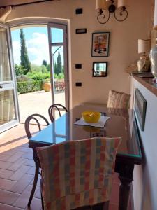 a kitchen with a table and chairs and a window at Castello di Fulignano Leonardo apartment ground floor in San Gimignano +35 photos
