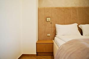 a bedroom with a bed and a night stand next to it at Apartament Thaddeus 48 z tarasem in Zator