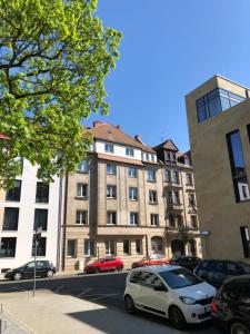 a white car parked in front of a building at Lovely Apartment in Fürth nähe Hauptbahnhof in Fürth
