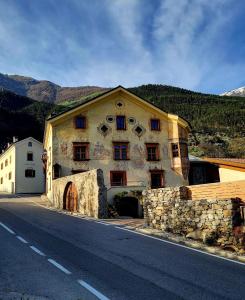 a large building on the side of a road at Großschlipfhof in Silandro