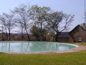 a large pool of water in the yard of a house at Bushveld Venue in Mabula