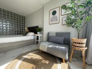 a bedroom with a bed and a chair and a table at APTO Exelsior, Yumbo, Dunas y Playa in San Bartolomé de Tirajana +21 photos