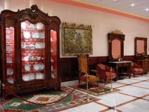 a room with a china cabinet with plates on it at Hotel Begoña Park in Gijón