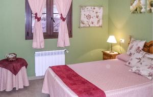 a bedroom with a bed with pink sheets and a window at 2 Bedroom Amazing Apartment In Villaviciosa in Villaviciosa