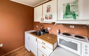 a small kitchen with a sink and a microwave at 1 Bedroom Awesome Apartment In Stavanger in Stavanger