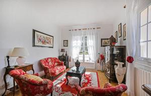 a living room with two chairs and a table at Lovely Home In Saint-Julien-Les-Rosie in Saint Julien Les Rosiers