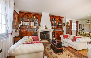 a living room with two couches and a fireplace at Lovely Home In Saint-Julien-Les-Rosie in Saint Julien Les Rosiers