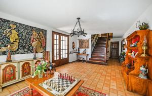 a living room with a chess board on a table at Lovely Home In Saint-Julien-Les-Rosie in Saint Julien Les Rosiers