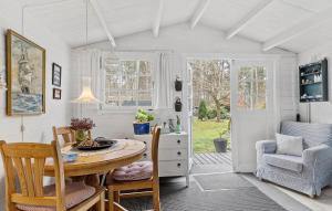 a dining room with a table and chairs at 2 Bedroom Stunning Home In Havndal in Havndal