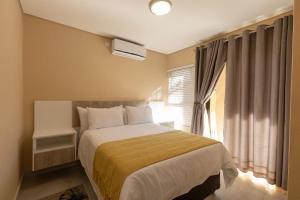 מיטה או מיטות בחדר ב-Kgaba Villas
