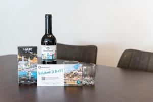 a bottle of wine sitting on a table with a glass at GuestReady - Modern apt near Matosinhos Beach in Matosinhos