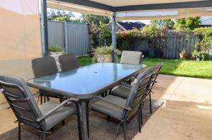 a blue table and chairs in a yard at Bj comfy home in Wellard