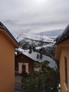 a house with a snow covered mountain in the background at BUENAVISTA LUXURY in Sierra Nevada
