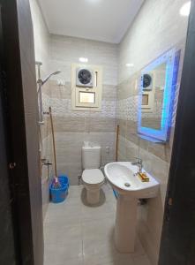 a bathroom with a toilet and a sink at LASIRENA PALM BEACH RESORT -FAMILY in Ain Sokhna