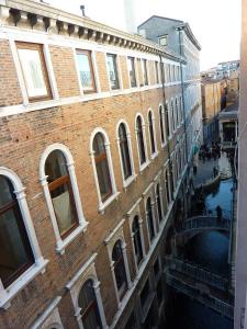 a large brick building with a canal in front of it at Corte delle Ancore in Venice