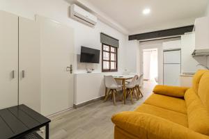 a living room with a couch and a table at Allo Apartments Arroyo Catedral in Jerez de la Frontera