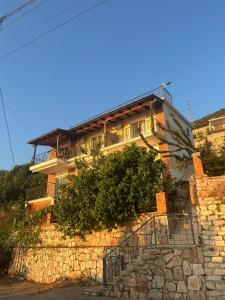 a building on top of a stone wall at Evita's House in Lukovë