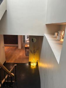 a staircase with a vase on a table in a room at Maï Homes - La Villa Bompard in Marseille