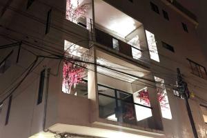 a large building with windows and lights on it at Tranquil refuge in Xalapa, 3BR 1BA apt for 6 in Xalapa