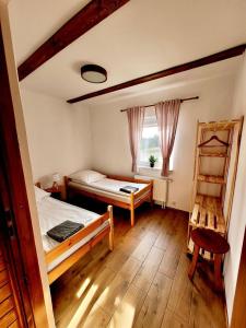 a bedroom with a bed and a ladder and a window at Petrico Camp Resort in Krzywopłoty