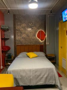 a bedroom with a bed with a yellow pillow at Templos, Brás, Expo Center Norte, Anhembi, 25 in Sao Paulo