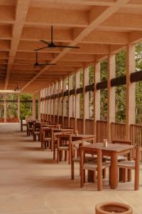 a row of tables and benches in a pavilion at Boca de Agua Bacalar in Bacalar