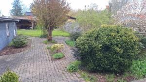 a garden with bushes and a brick walkway at Room in Ubby (Near Kalundborg) in Kalundborg
