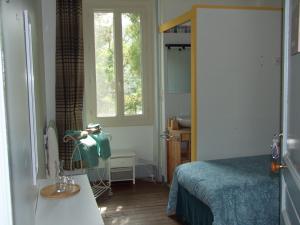 a small bedroom with a bed and a window at Au Bois de la Grave in Luzech