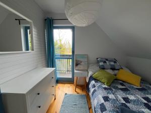 1 dormitorio con cama, escritorio y ventana en Domek wakacyjny MĄTWA - 150 metrów od plaży! en Karwieńskie Błoto Pierwsze