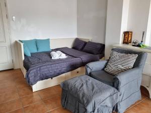 a room with a bed and a couch and a chair at Avatara B condominium B54 in Ban Tha Fat +30 photos