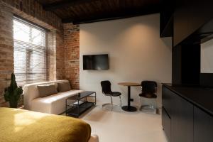 a living room with a couch and a table at Hortus Vilnius in Vilnius